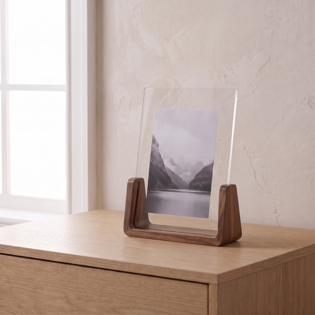 Fana frame, vertical, walnut wood, holding a landscape print on an oak dresser