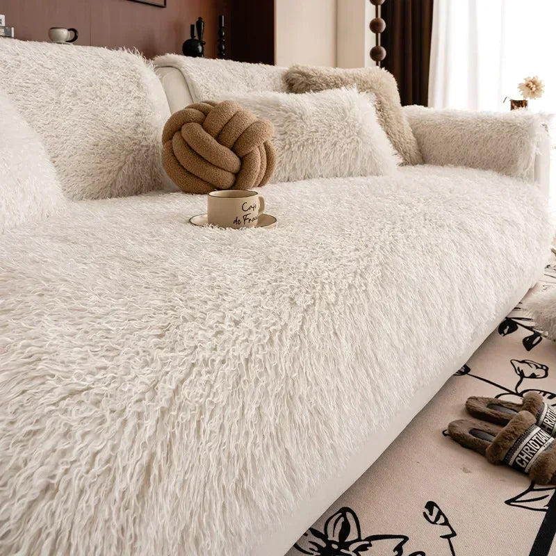 Off white faux lambswool sofa cover with a knot cushion