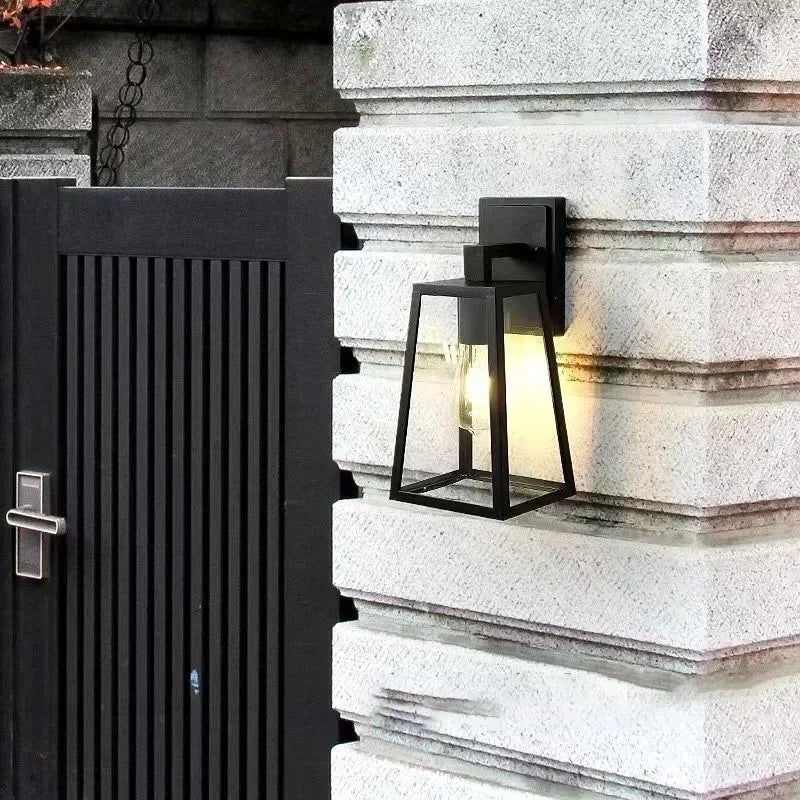 Fjell lantern on a stone pillar beside a black gate