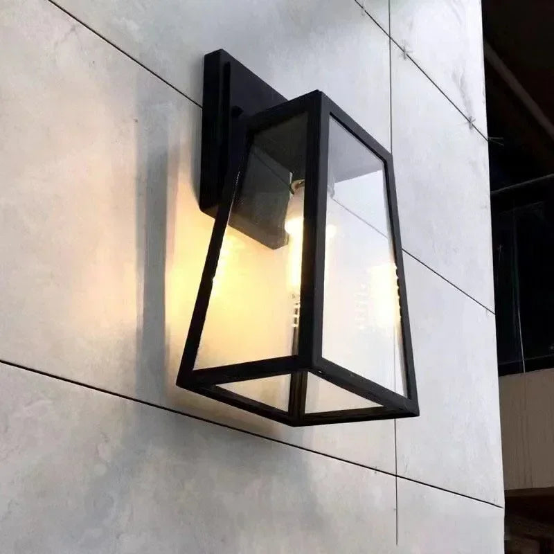 Fjell lantern lit on a gray tiled facade