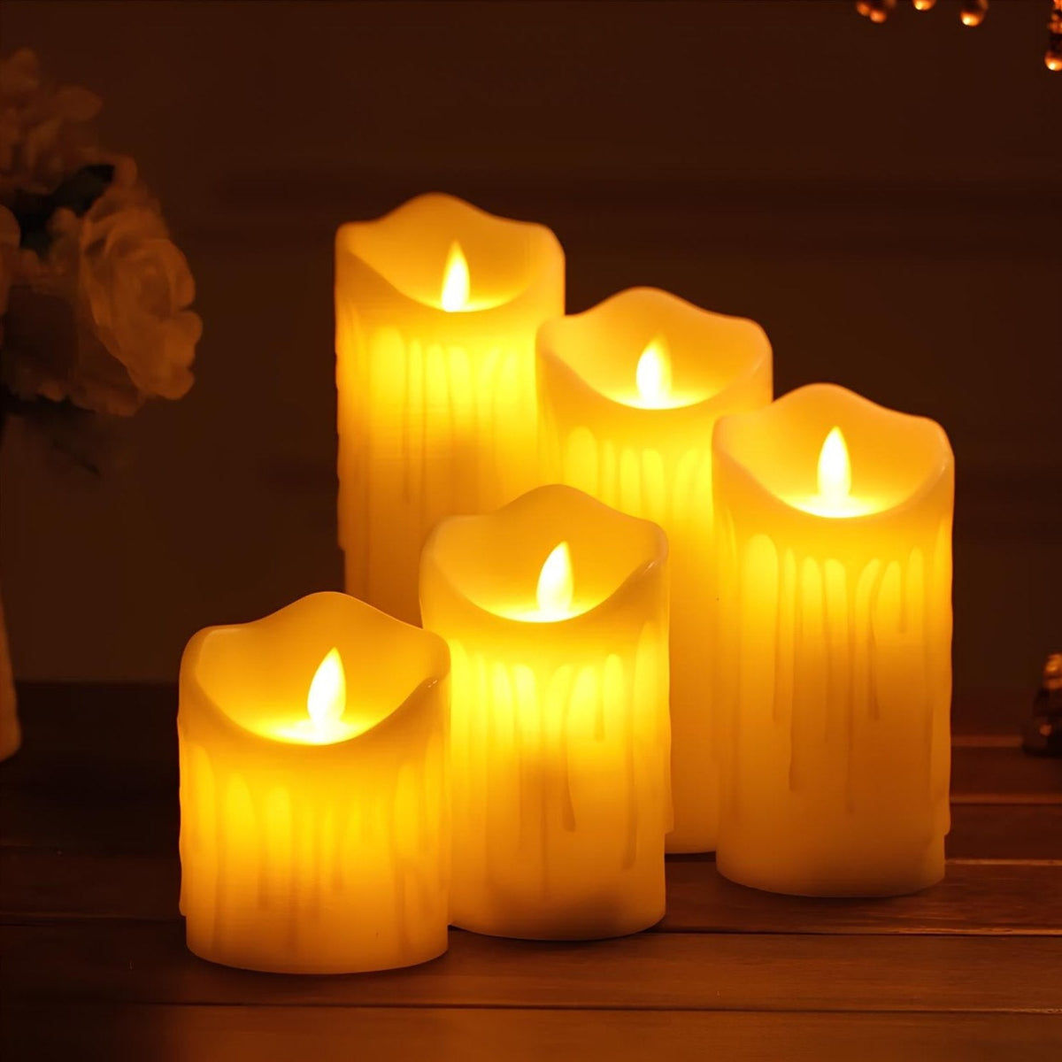 Five melting flameless pillar candles lit