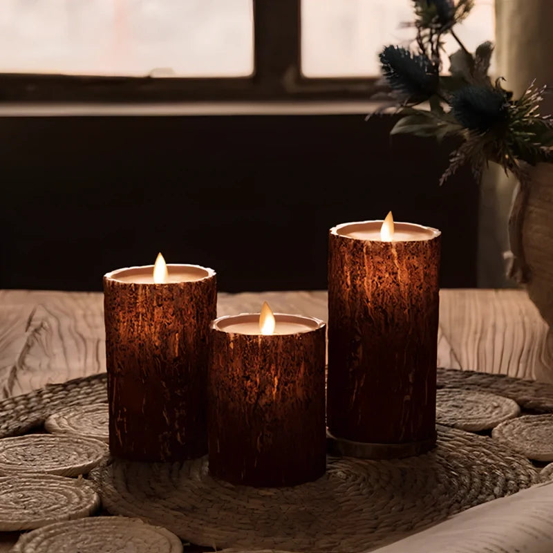 Three bark finish flameless candles on a woven mat