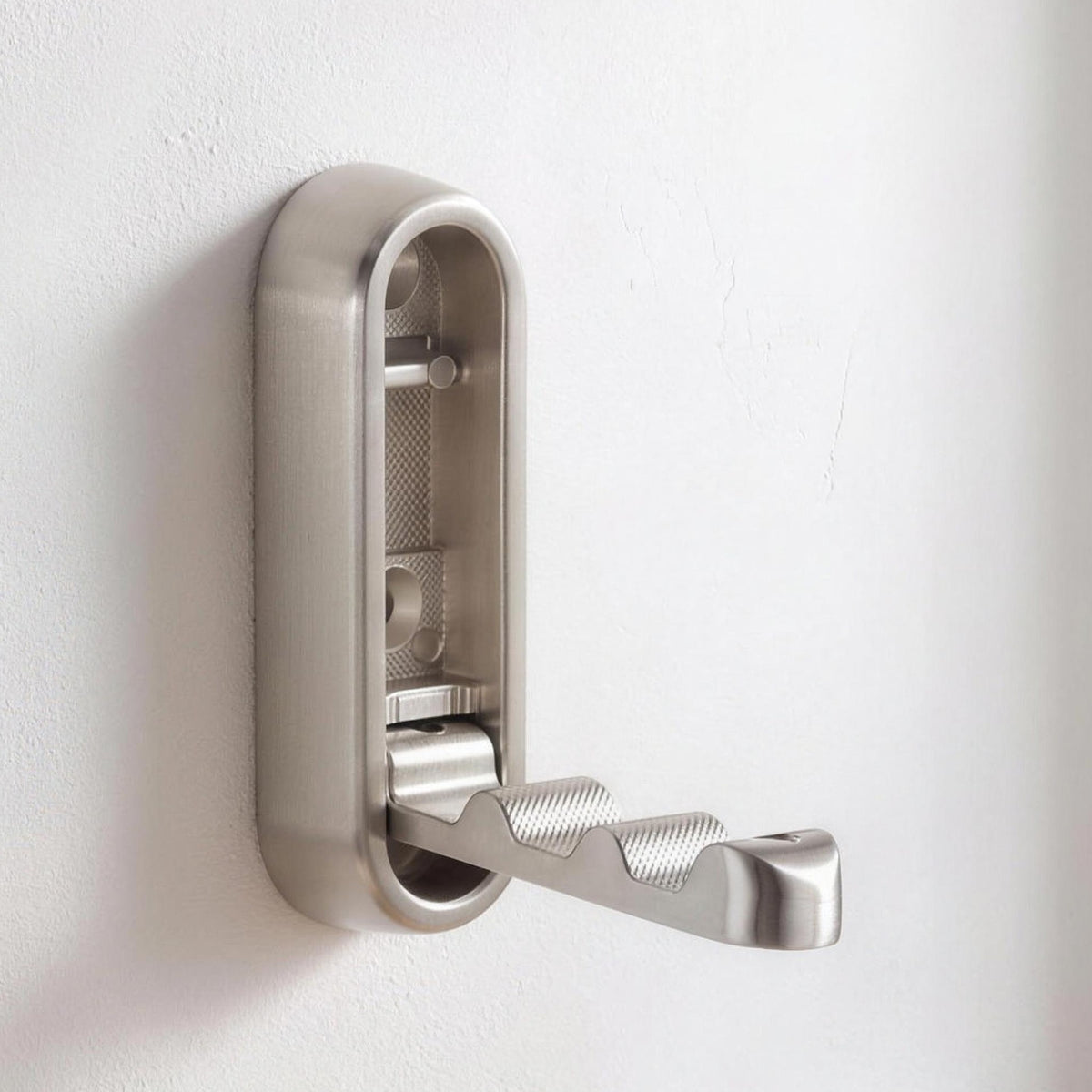 Folding wall hook in Silver opened out on a white wall