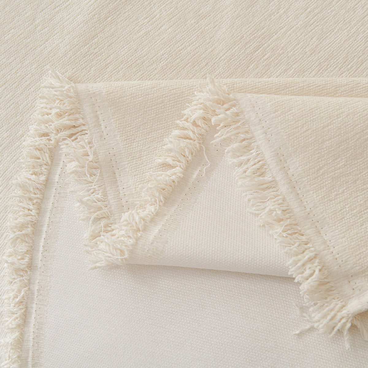 Close view of the cream fringed edge