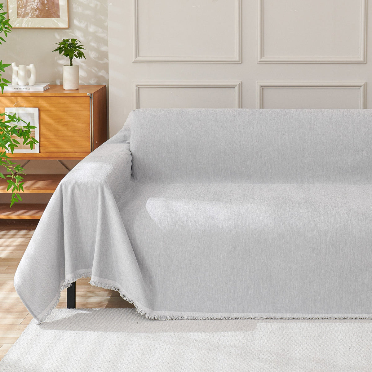 Light gray woven cover draped over a sofa