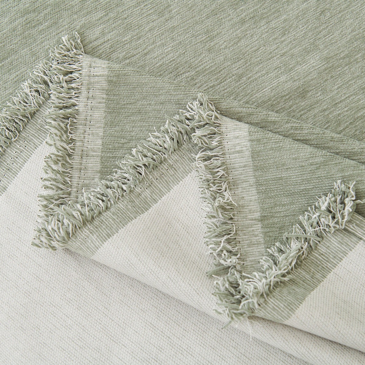 Close view of the sage green fringed edge