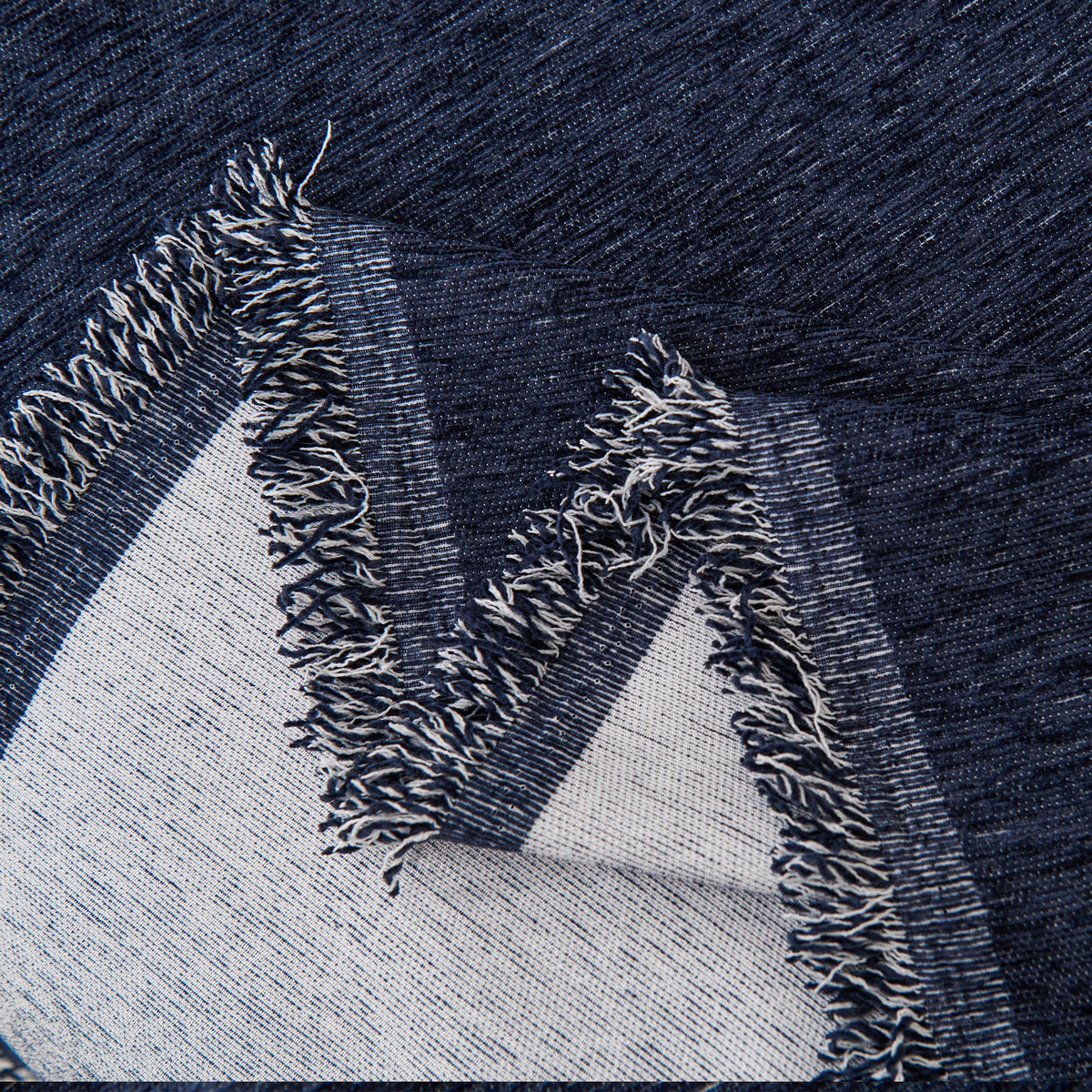Close view of the navy blue fringed edge