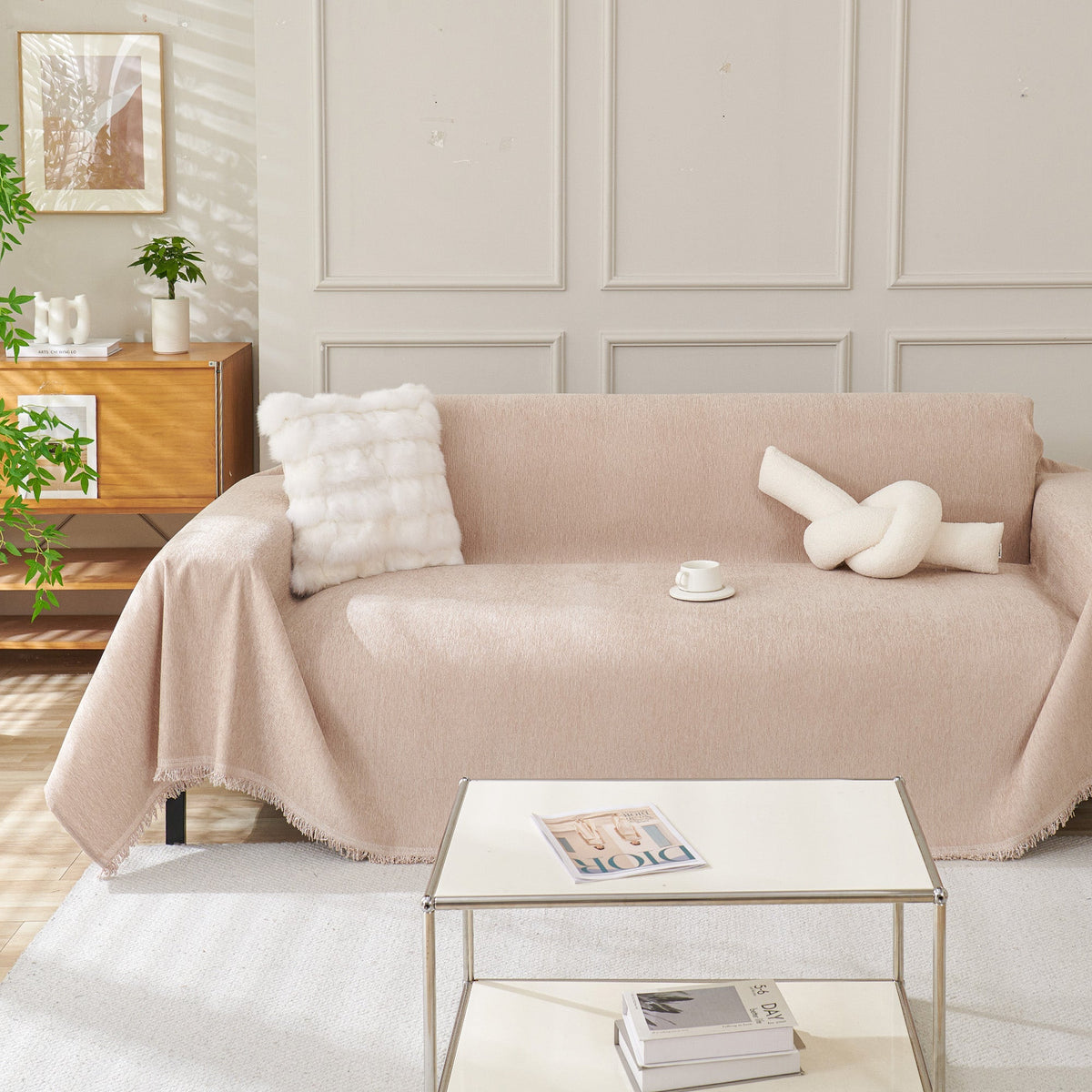 Blush pink woven sofa cover over a sofa