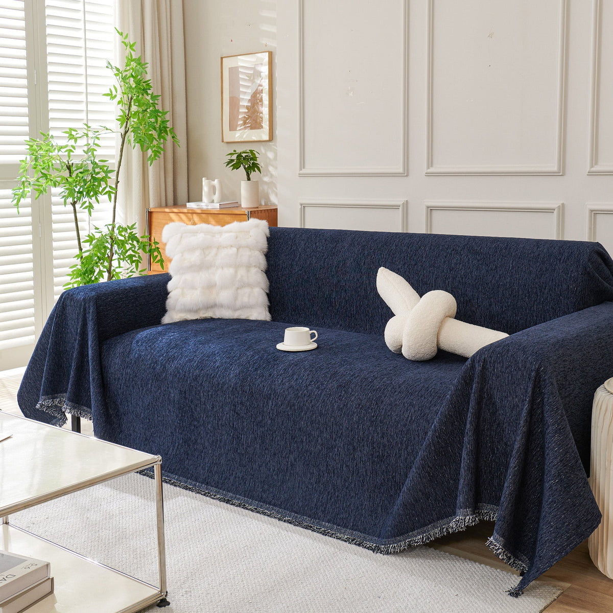 Navy blue woven sofa cover over a sofa