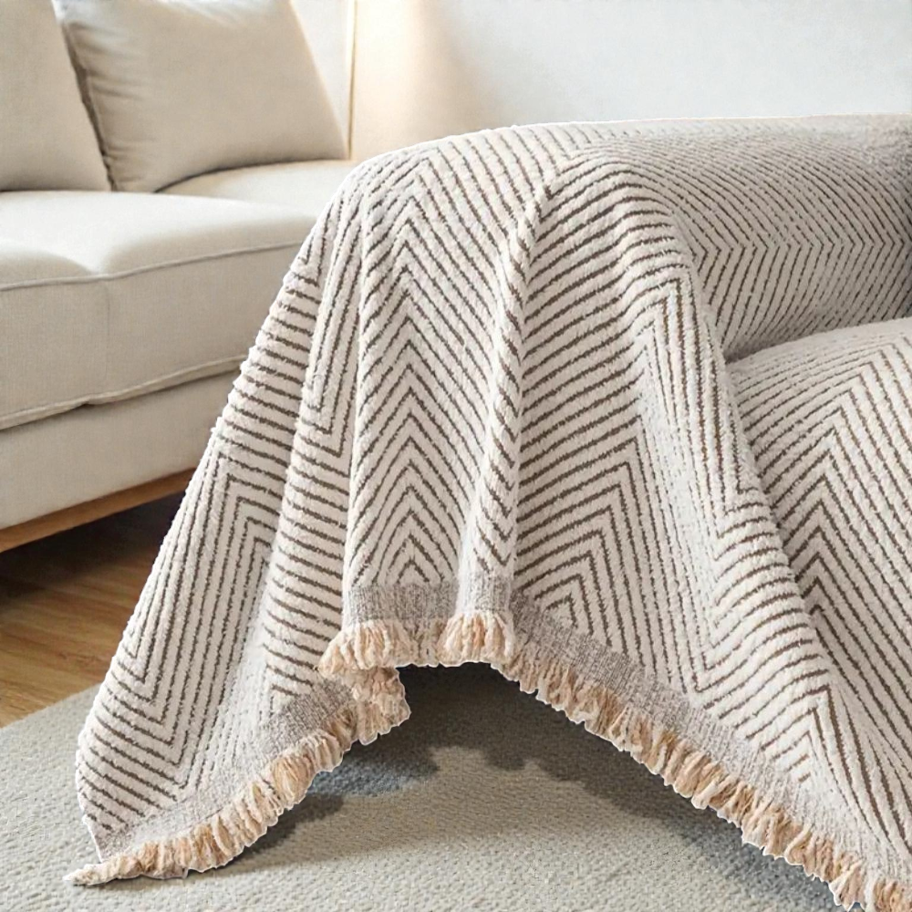 Ivory herringbone cover hanging off the end of a sofa to the floor