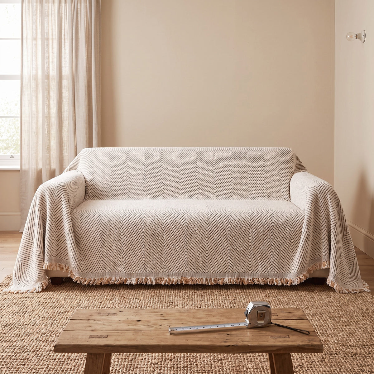 Couch Cover in Ivory on a sofa, sized by arm to arm