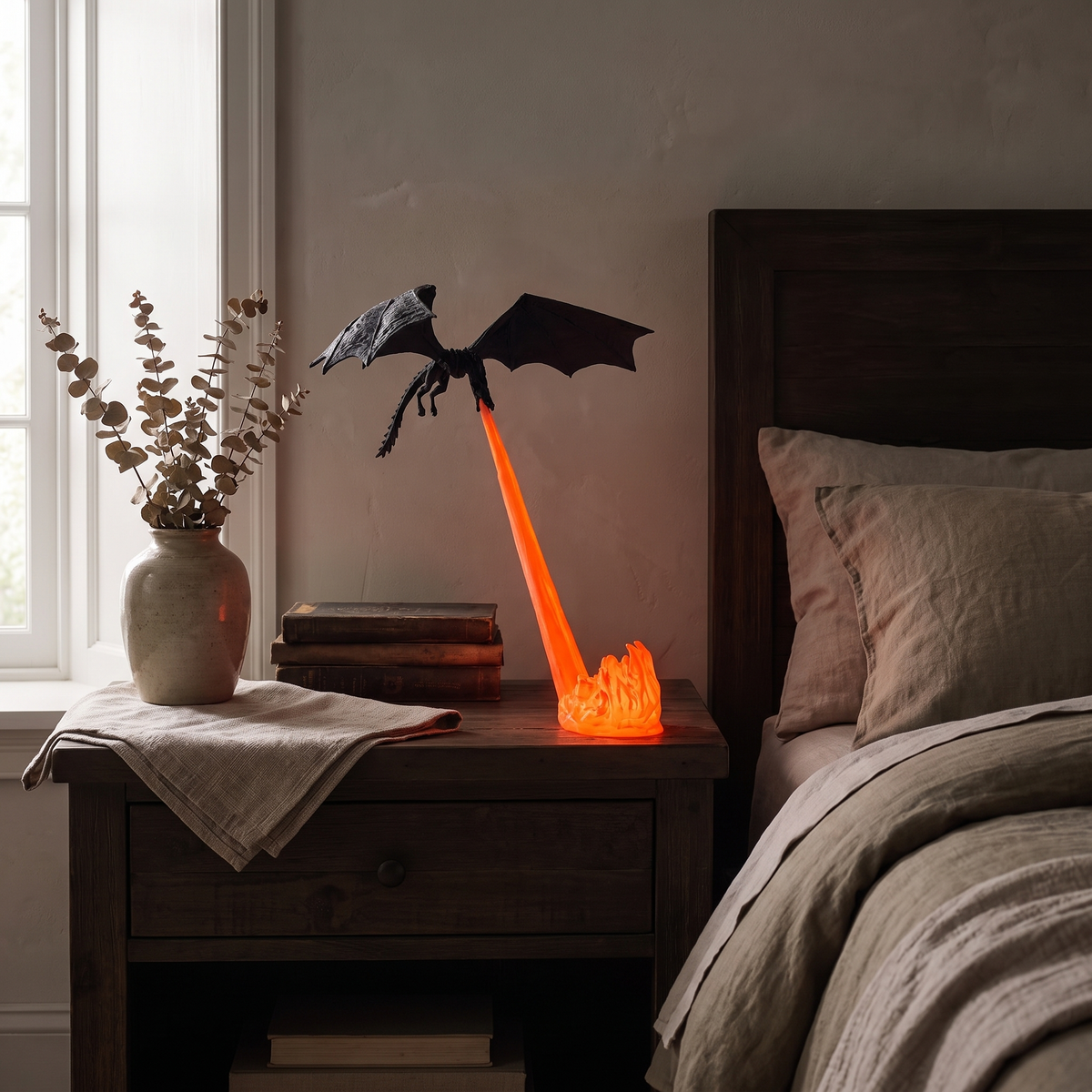 Holte dragon night light glowing on a bedroom nightstand