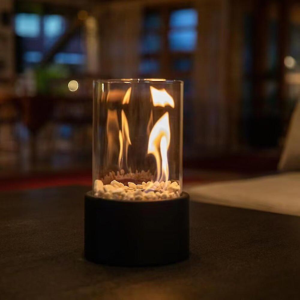 Horten fire lamp lit on a table at night