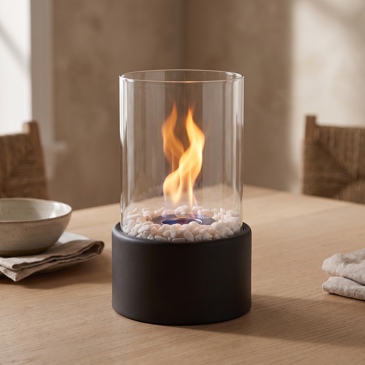 Horten tabletop fire lamp in black lit on an oak dining table