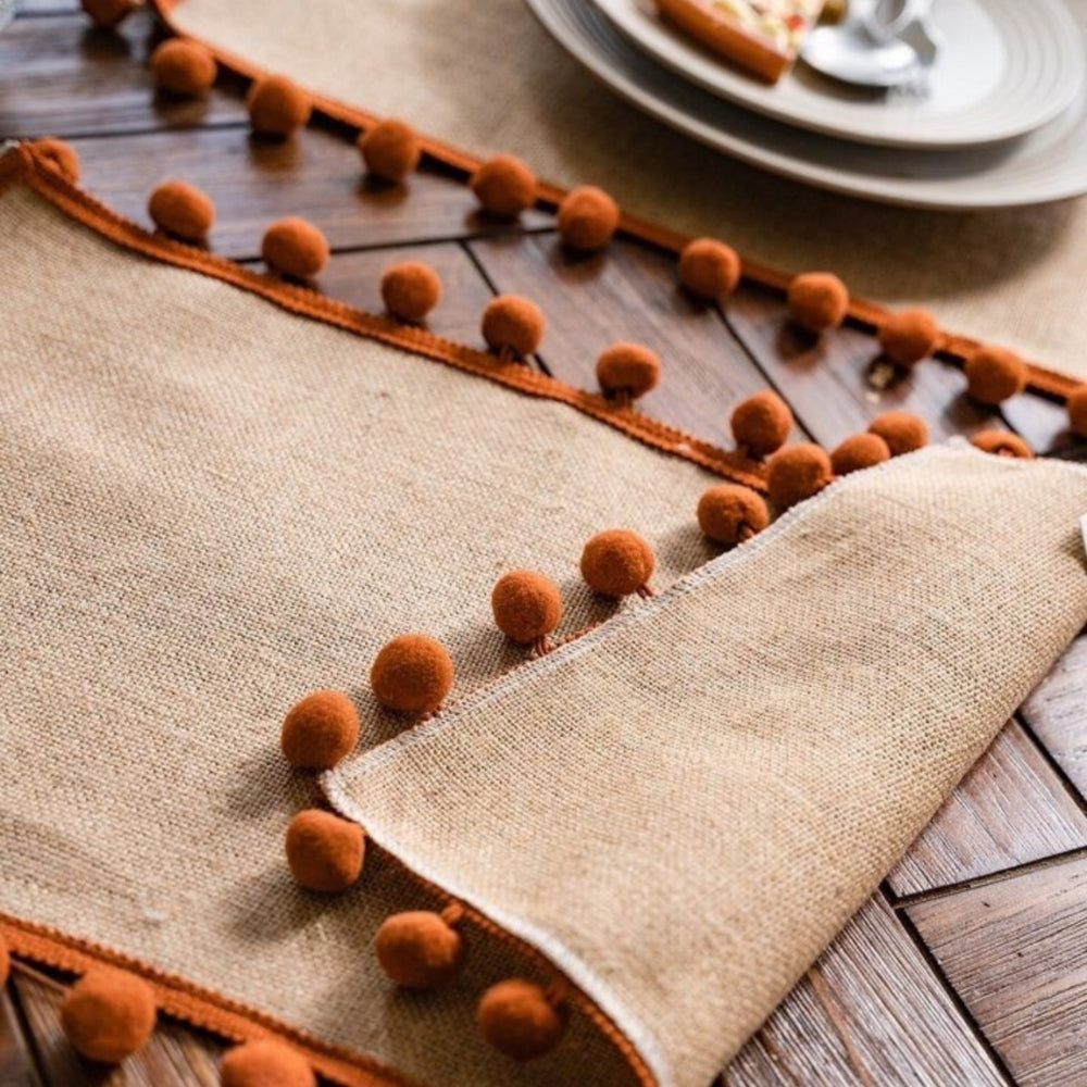 Close view of the pom pom trim along the runner edge