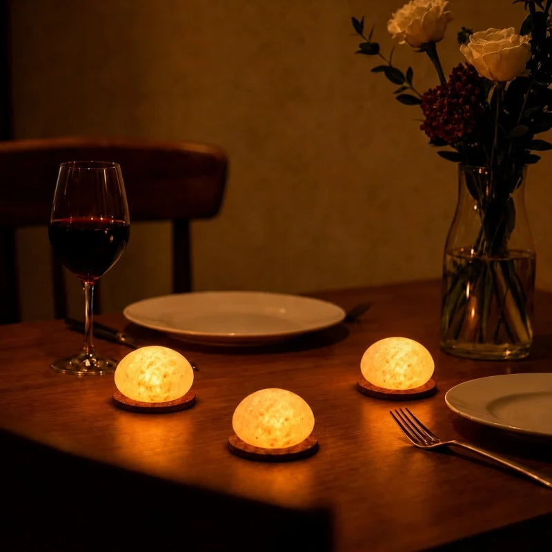 Three Kvist dome lights lit on a dinner table