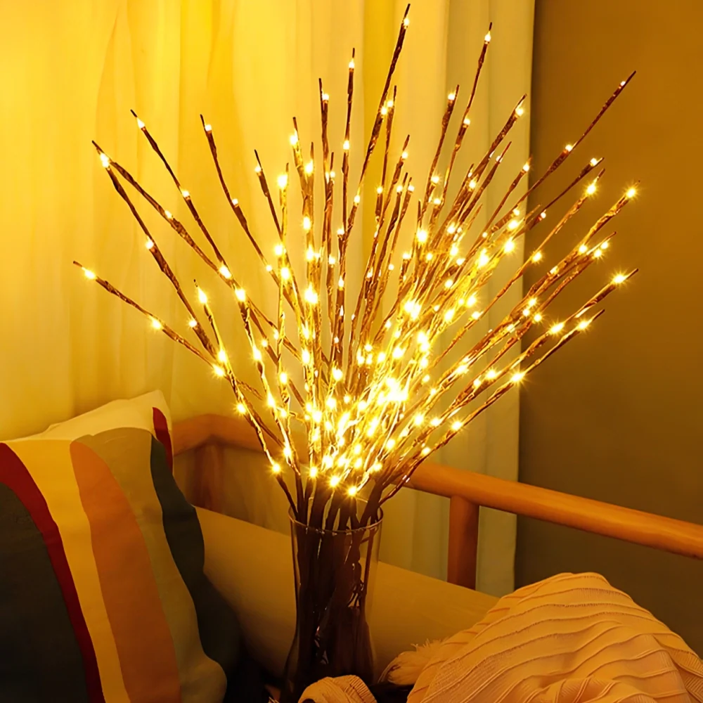 Lighted willow branches in a dark vase