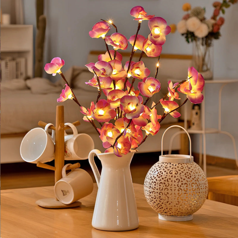 Lighted purple orchid branches in a white pitcher