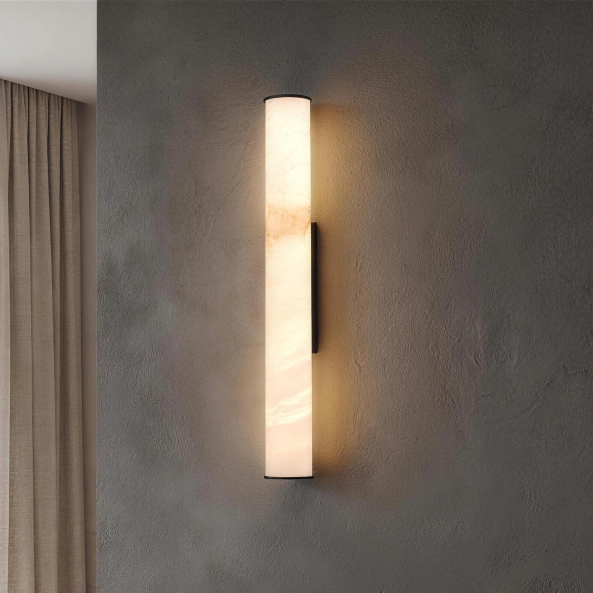 Linn wall sconce, black, alabaster tube lit on a plaster wall