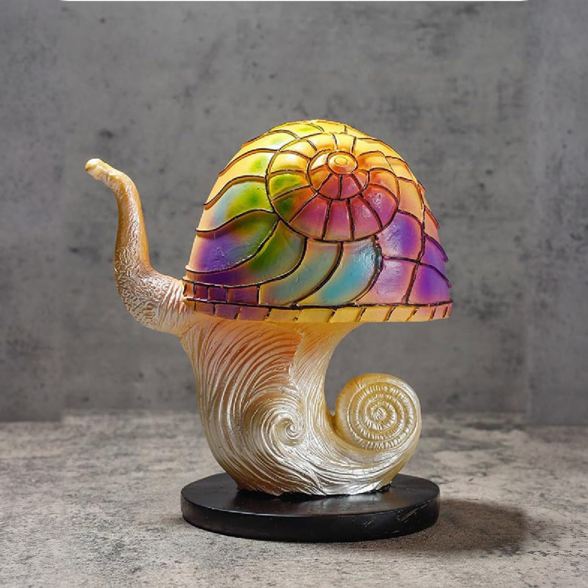 Colorful Snail Majken table lamp on a stone surface