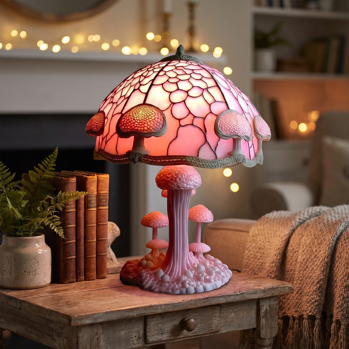 Pink Majken mushroom lamp lit on a side table in a cozy room