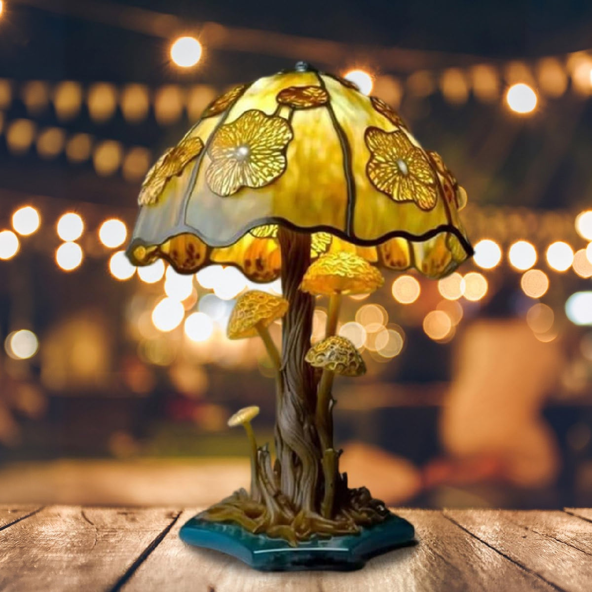 Yellow Flower Majken table lamp lit on a wooden table