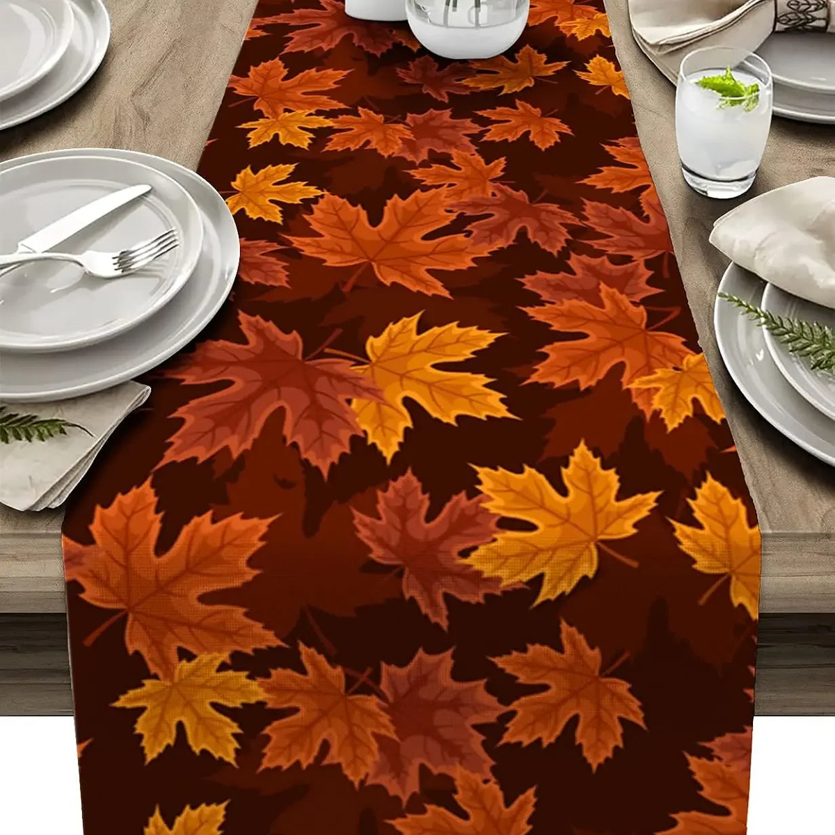 Maple leaf print runner down a table set with white plates
