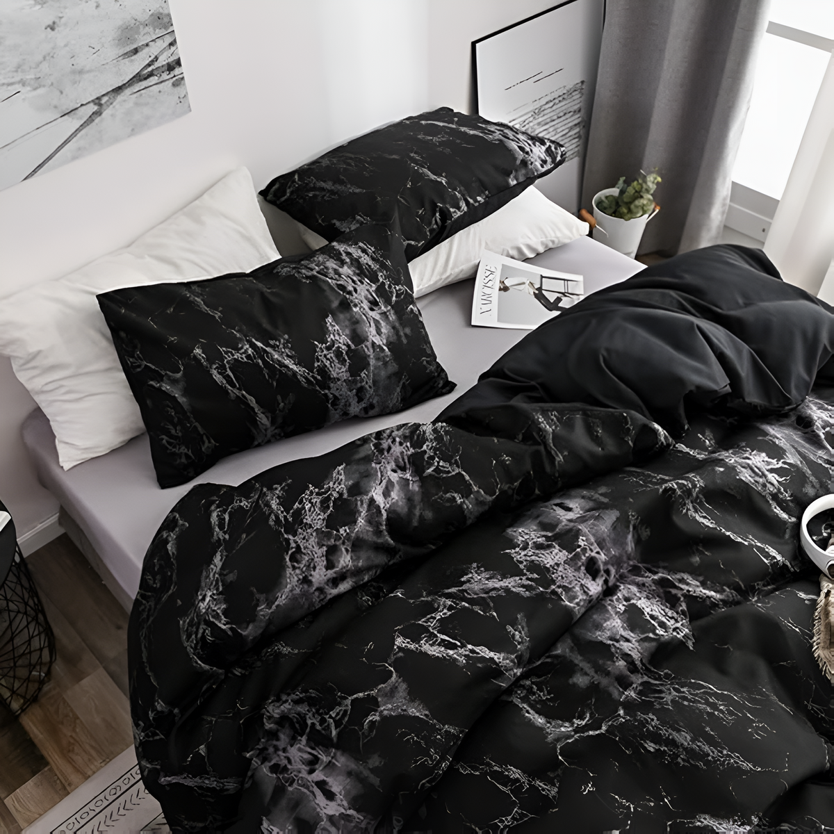 Black marble duvet and pillowcase on a bed beside white pillows