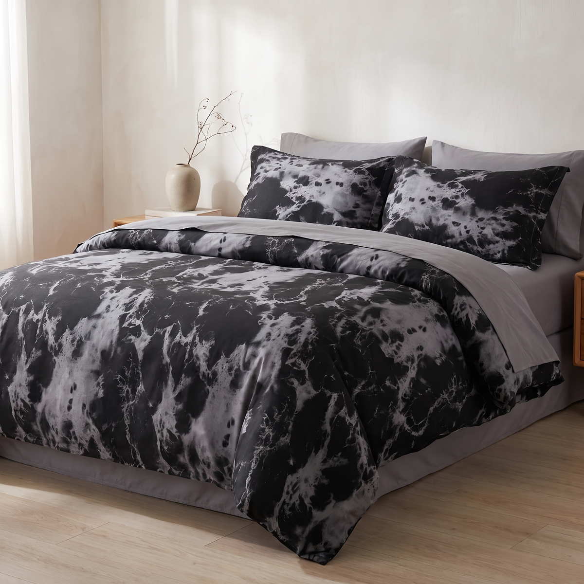 Black marble duvet cover set with two pillowcases on a made bed
