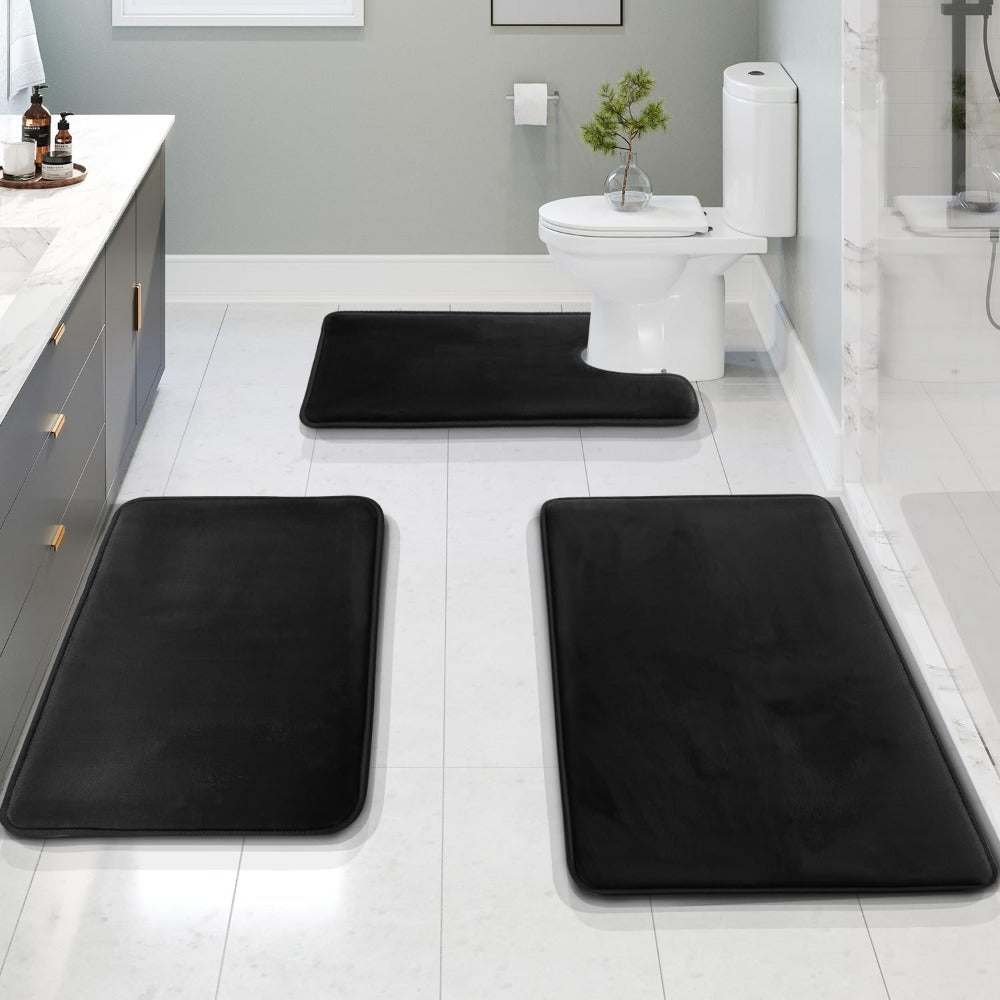 Black bath mat set on a white tile floor