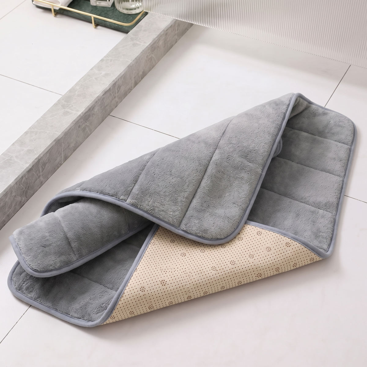 Close view of the ribbed microfiber bath mat with a corner folded to show the non slip backing