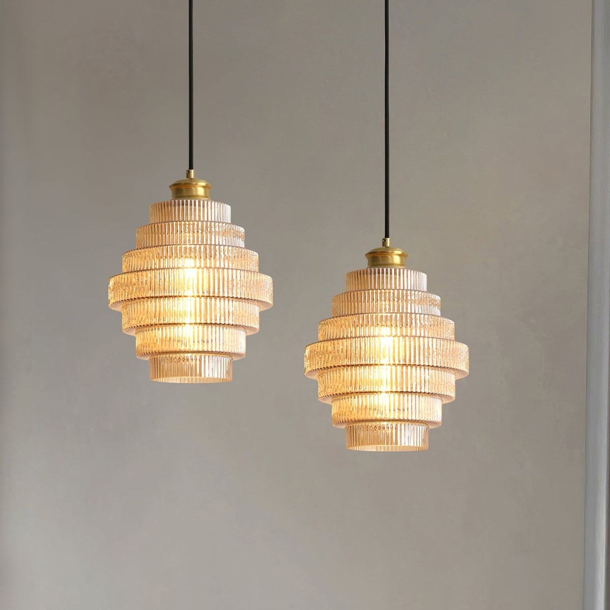 A pair of amber Minna pendant lights hung at two heights