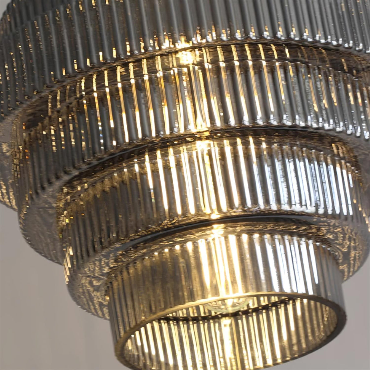 Close view of the smoke gray ridged glass tiers of the Minna pendant