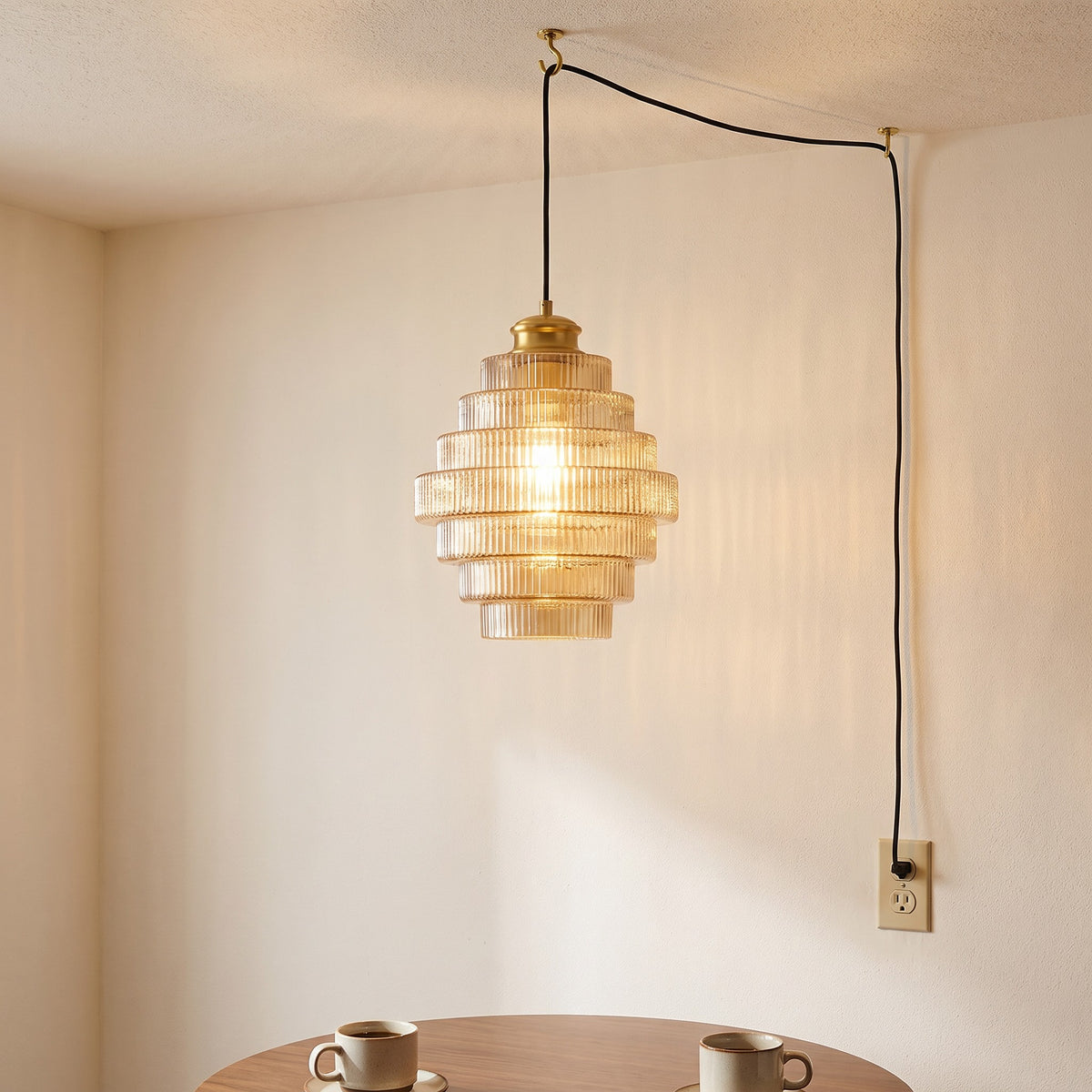 Minna pendant light in amber hanging above a round breakfast table with two coffee cups