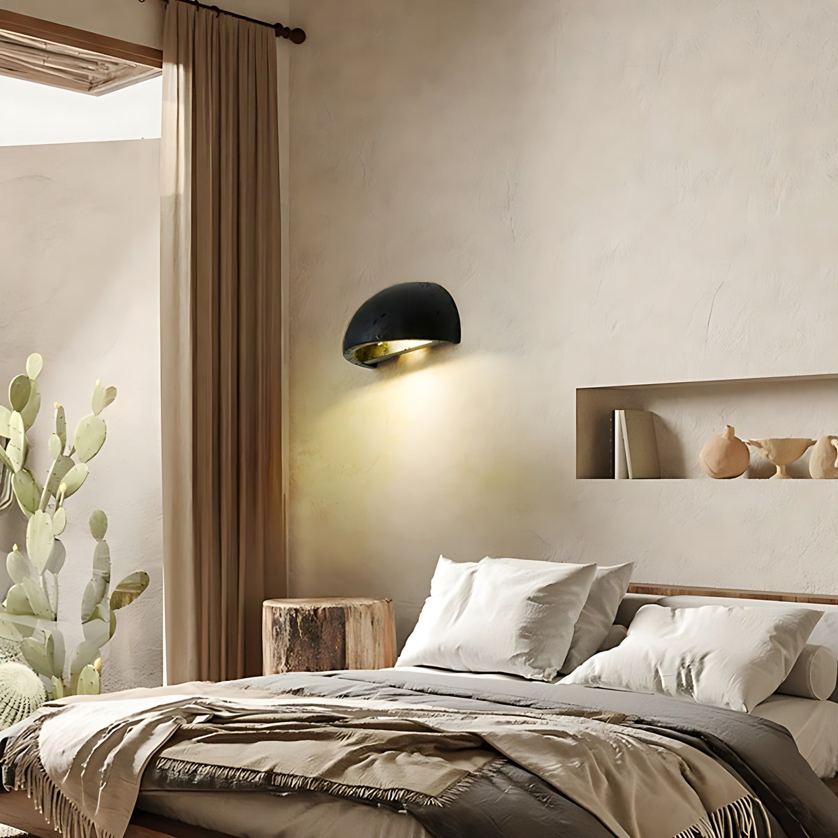 Black travertine Mira LED wall sconce in a bedroom