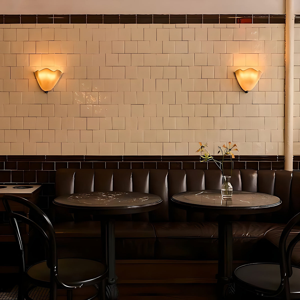 Two Moa wall sconces on a cafe wall