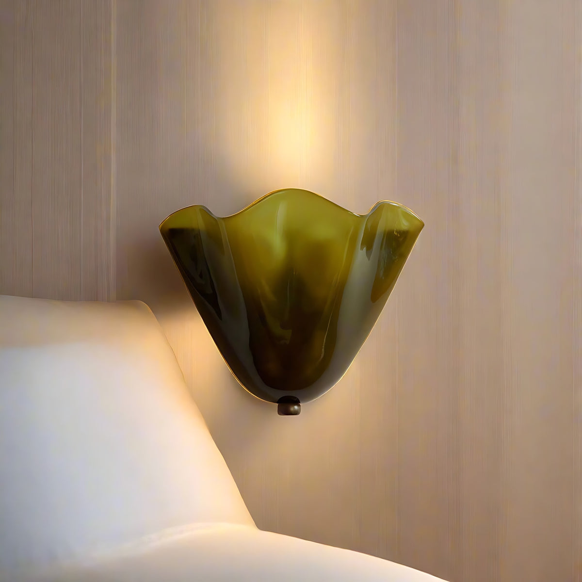 Green Moa wall sconce beside a bed