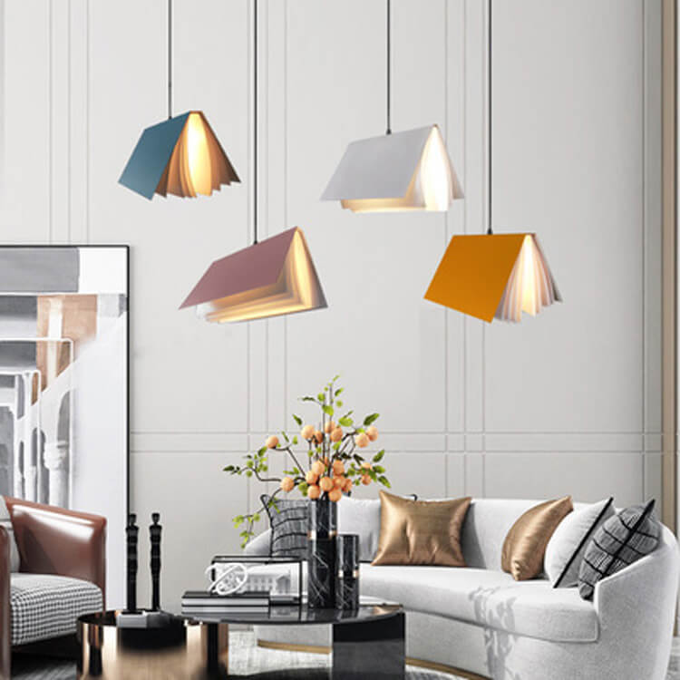 Blue, pink, white and yellow book pendants hanging in a bright living room