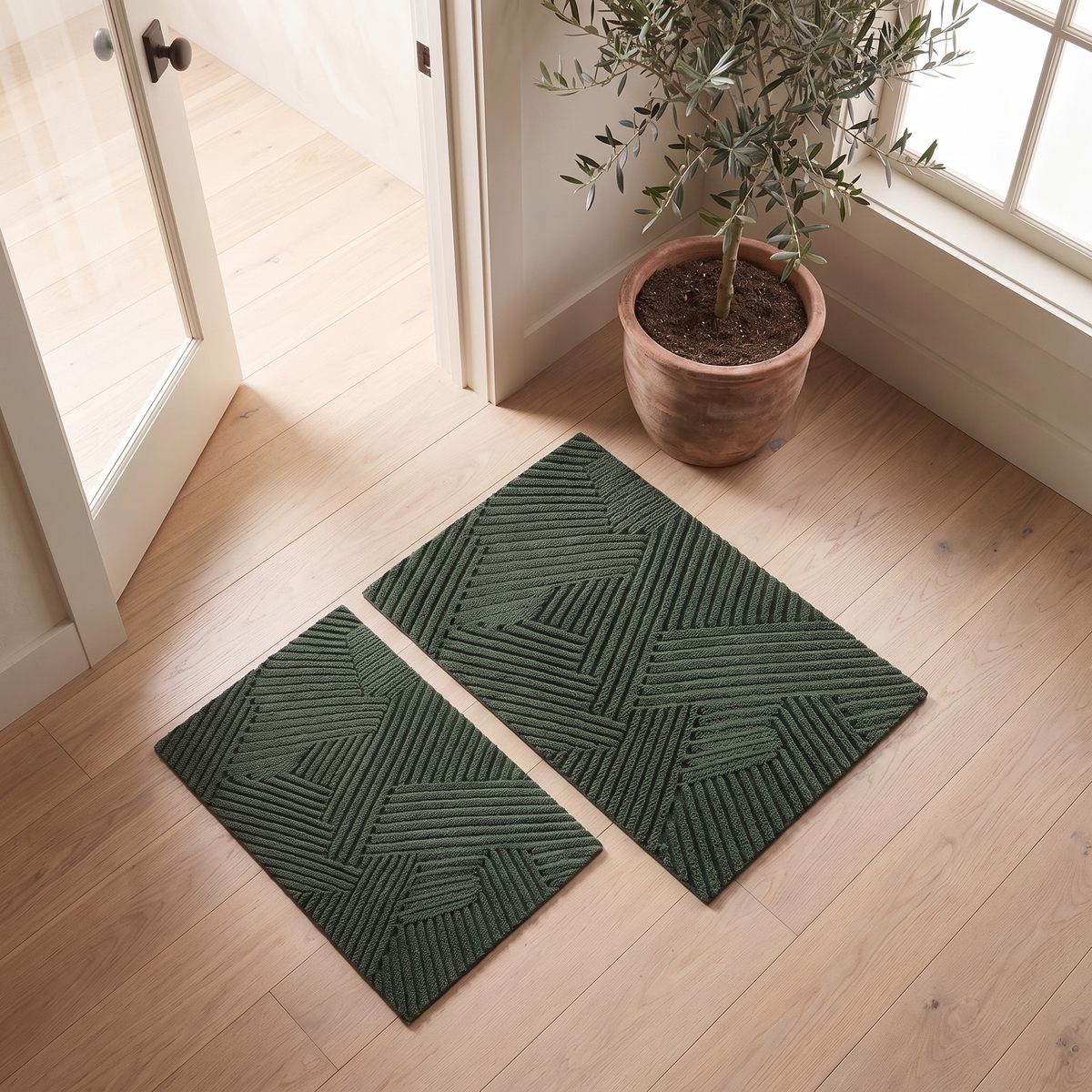 Door mat in two sizes side by side, 18 by 30 and 24 by 35 inches
