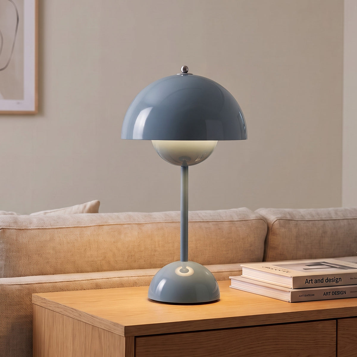 Oona table lamp in Blue Gray on a sideboard beside a sofa