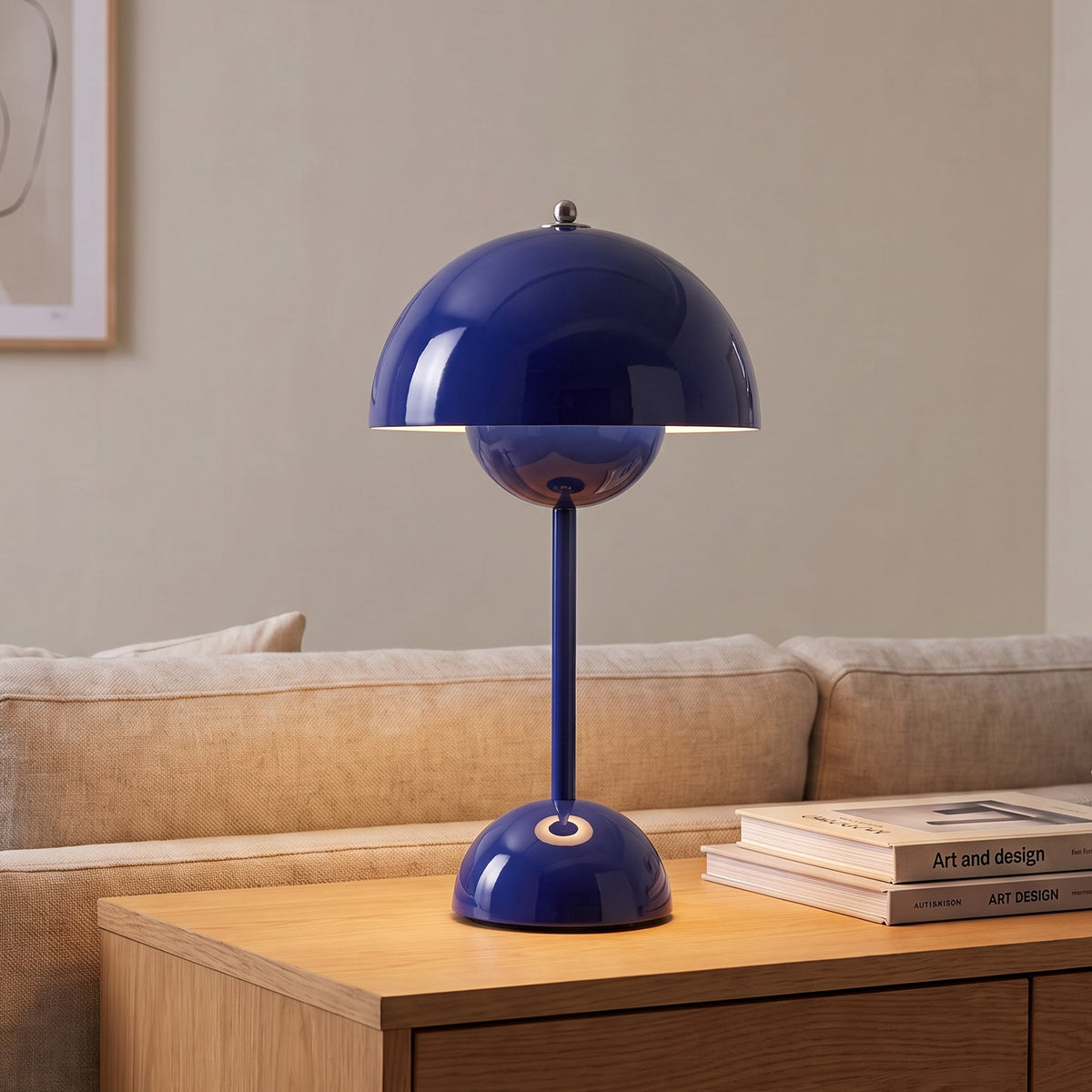 Oona table lamp in Dark Blue on a sideboard beside a sofa