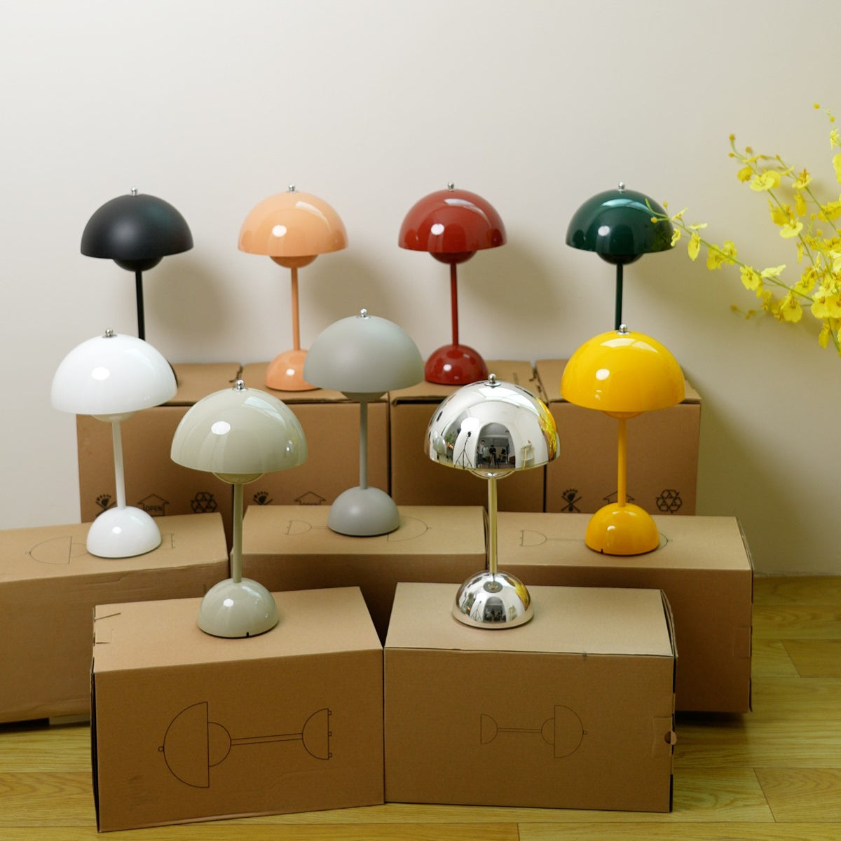 Oona table lamps in many colors standing on their shipping boxes