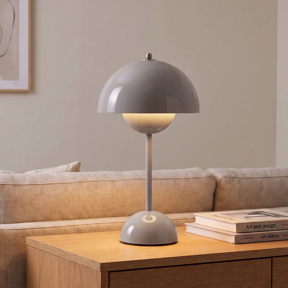 Oona table lamp in Gray on a sideboard beside a sofa