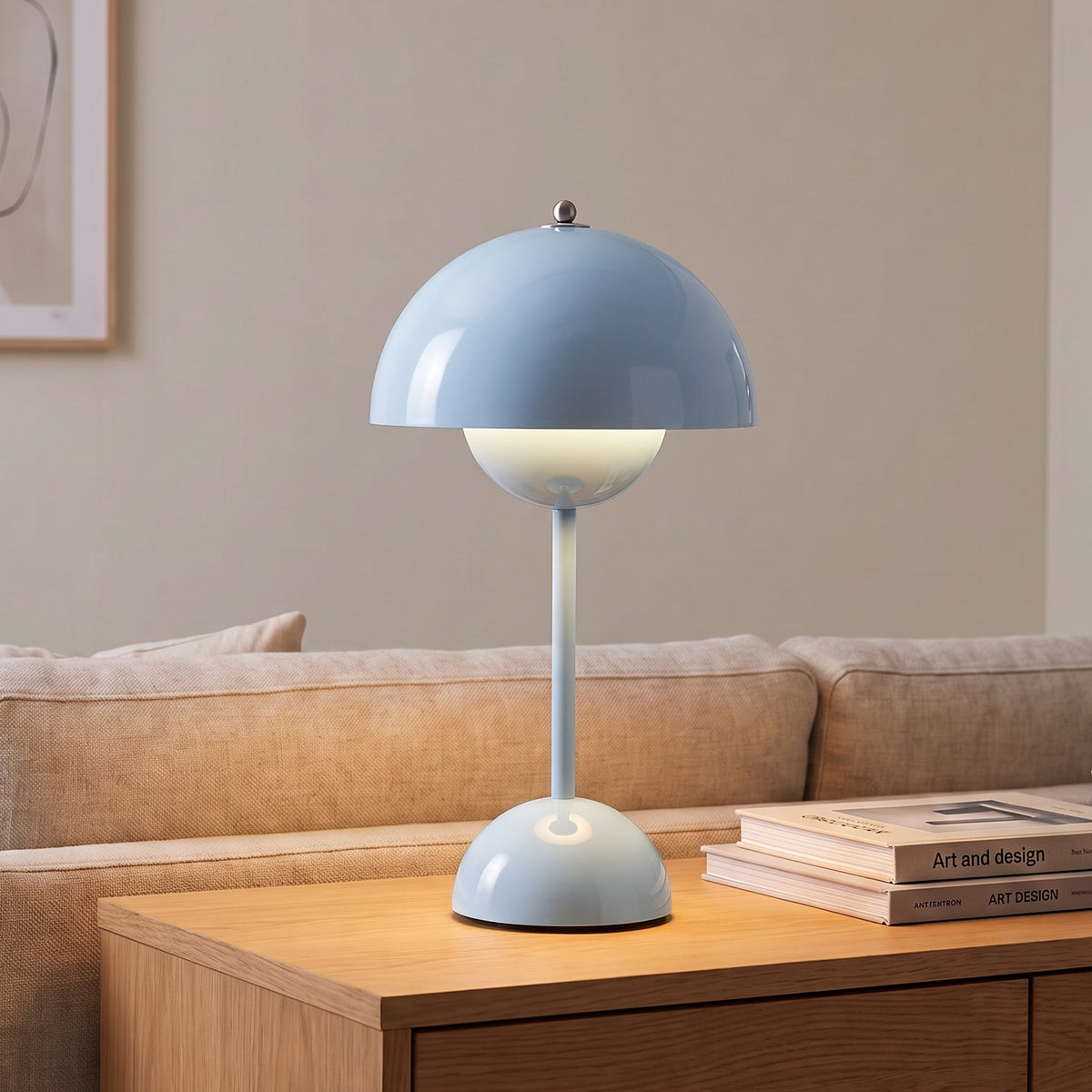 Oona table lamp in Light Blue on a sideboard beside a sofa