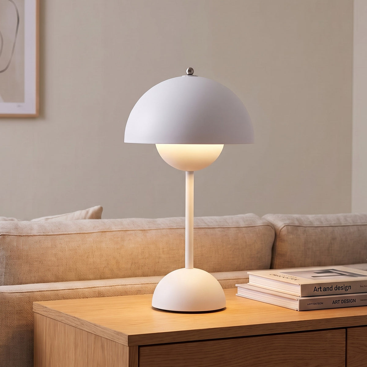 Oona table lamp in Matte White on a sideboard beside a sofa