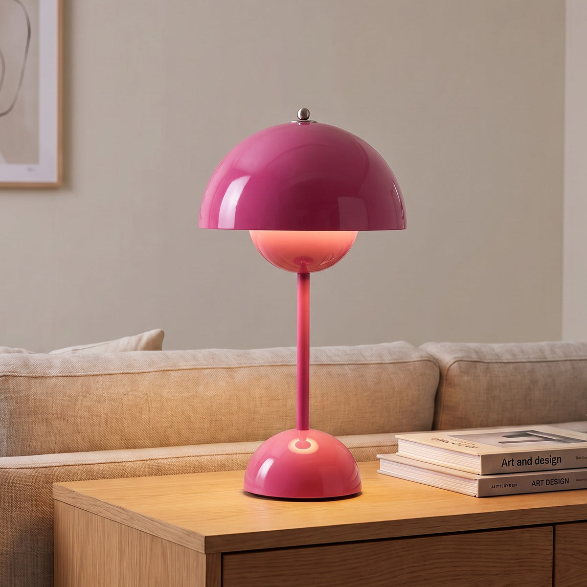 Oona table lamp in Rose Red on a sideboard beside a sofa