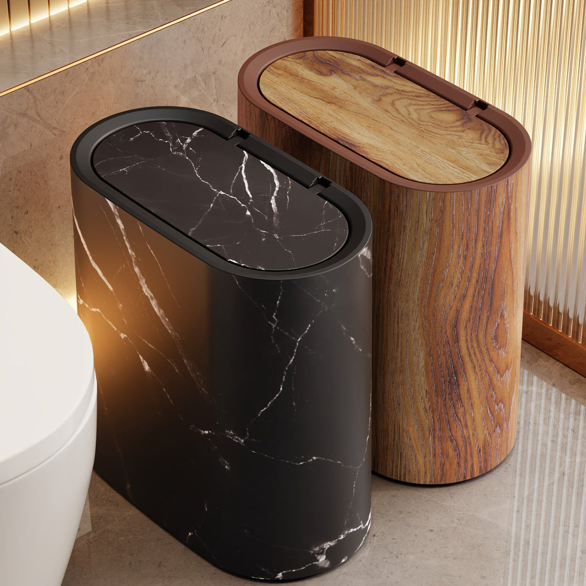 Black marble oval waste bin with the lid flipped open beside a toilet