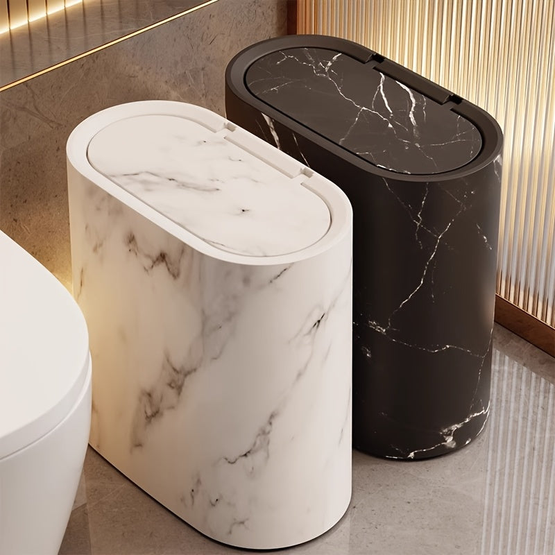 Cream marble oval waste bin on a tiled bathroom floor