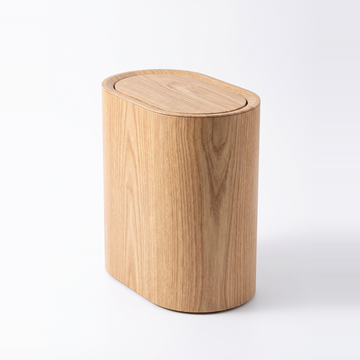 Oval waste bin in light wood grain finish on white