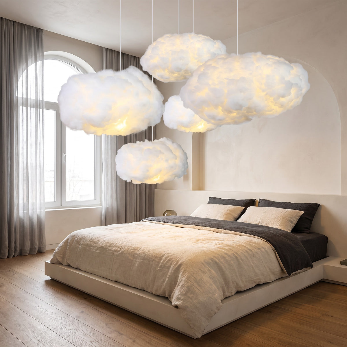 Group of Petra cloud pendant lights glowing over a bedroom